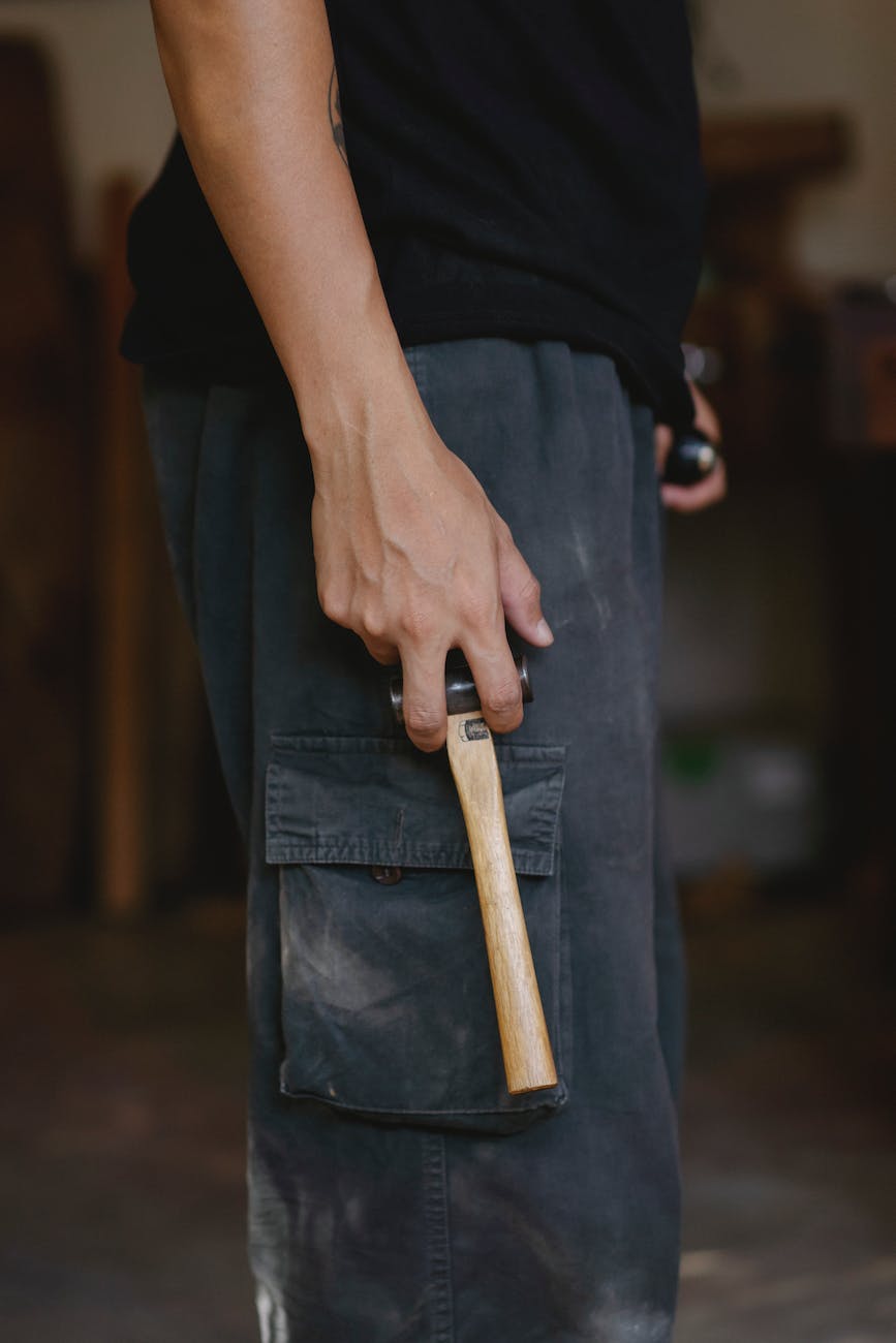 craftsman with hammer in workshop